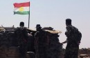 Members of Kurdish Peshmerga force stand guard at Sulaiman Pek front line