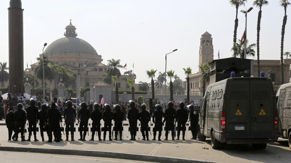 Riot police officers take positions in front of Cairo University