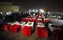The caskets of 25 policemen killed near the north Sinai town of Rafah lay on the ground after arriving in Cairo