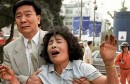 SEOUL, SOUTH KOREA - JUNE 29:  A frantic mother and her husband cry as they look for their missing daughter after an explosion and the collapse of the Sampoong Department store building in southern Seoul 29 June. At least 20 people were killed and hundreds hospitalized as rescue crews continued to dig for survivors.   AFP PHOTO  (Photo credit should read CHOO YOUN-KONG/AFP/Getty Images)