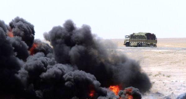 An Iraqi lorry passes by the the raging fire on Iraq's key oil export pipeline to Turkey two days after an act of sabotage in Baiji, a town about 200 kilometres (125 miles) north of Baghdad, 17 August 2003. "The damage to the pipeline means seven million dollars losses every day," said the US civil administrator for Iraq, Paul Bremer.  AFP PHOTO/MAXIM MARMUR  (Photo credit should read MAXIM MARMUR/AFP/Getty Images)