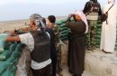 Tribal fighters carry their weapons as they take part in an intensive security deployment against Islamic State militants in the town of Amriyat al-Falluja,in Anbar province, October 31, 2014. Picture taken October 31, 2014.  REUTERS/ Stringer (IRAQ - Tags: CIVIL UNREST MILITARY)