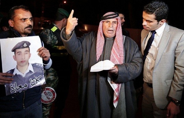 Yousef, father of Islamic State captive Jordanian pilot Kasaesbeh, reads a statement released by Islamic State during a demonstration to demand Jordanian government negotiate with Islamic State for release of Kasaesbah, in Amman