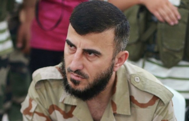 Zahran Alloush, commander of Jaysh al Islam, sits during a conference in the town of Douma, eastern Ghouta in Damascus