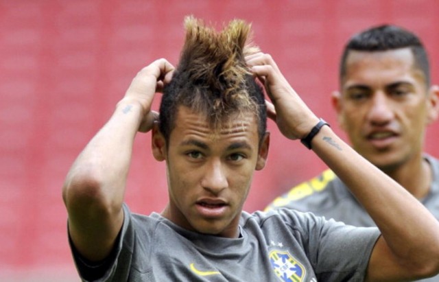 Brazil's forward Neymar fixes his hair d