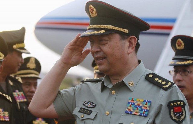 China's Defence Minister Chang Wanquan salutes as he greets Cambodian officials during his arrival at a Cambodian Air Force base in Phnom Penh