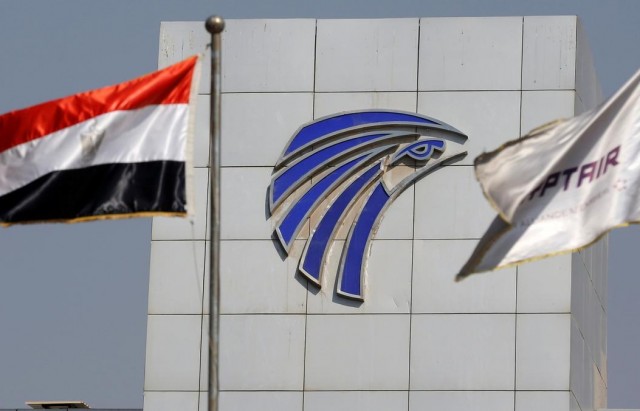 Egypt and EgyptAir flags are seen infront of an Egyptair in-flight service building at Cairo International Airport