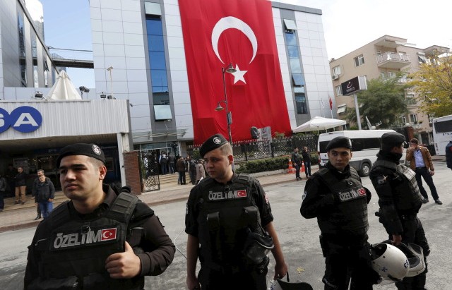 Riot police stand guard outside the Kanalturk and Bugun TV building in Istanbul