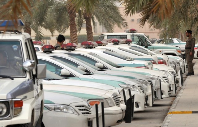 Saudi police cars are parked and policem