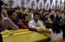 Relatives of victims react next to coffins arriving to the Coptic church that was bombed on Sunday in Tanta