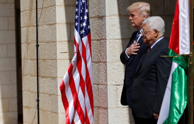 Palestinian President Mahmoud Abbas stands next to U.S. President Donald Trump during a reception ceremony at the presidential headquarters in the West Bank town of Bethlehem