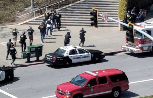 Law enforcement officials react following a possible shooting at the headquarters of YouTube in San Bruno, California