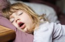 funny face of child sleeping on king bed