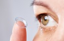 Young womans eye and contact lens
