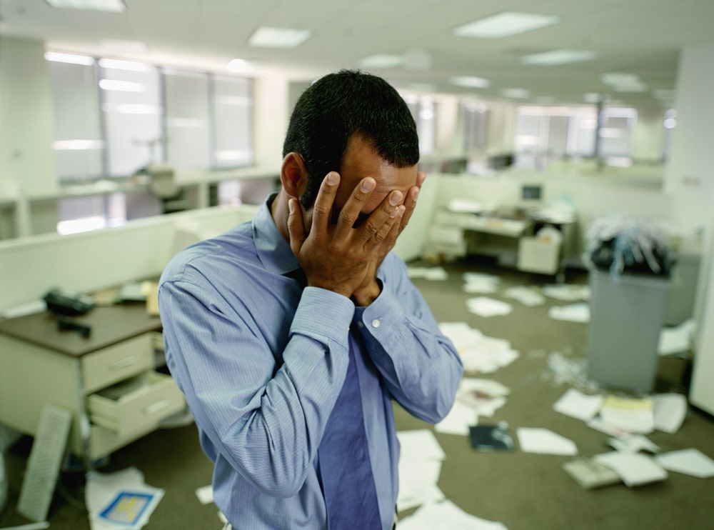 Stressed Businessman in Messy Office